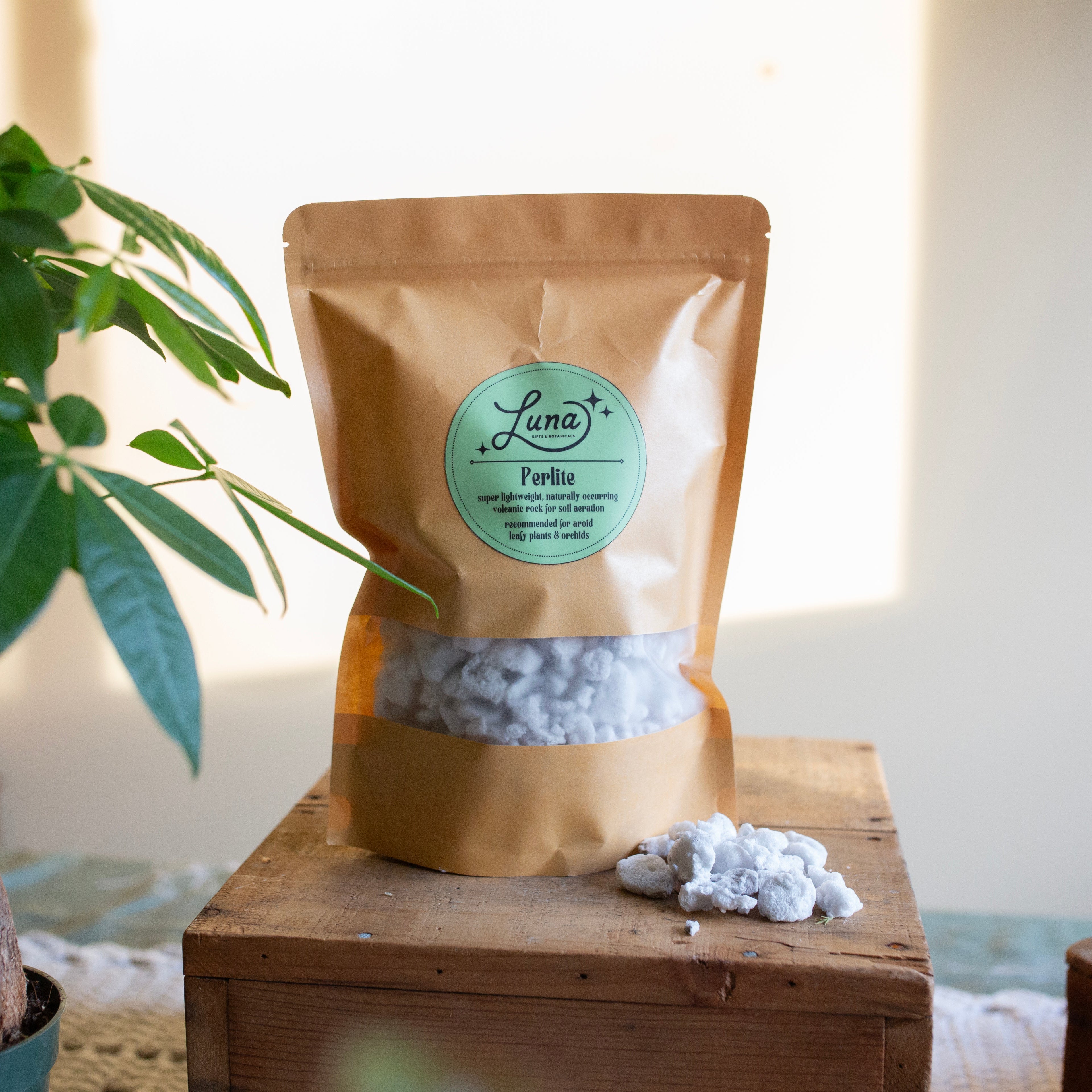 Bag with label of Perlite sitting on a wooden box with a blurred background
